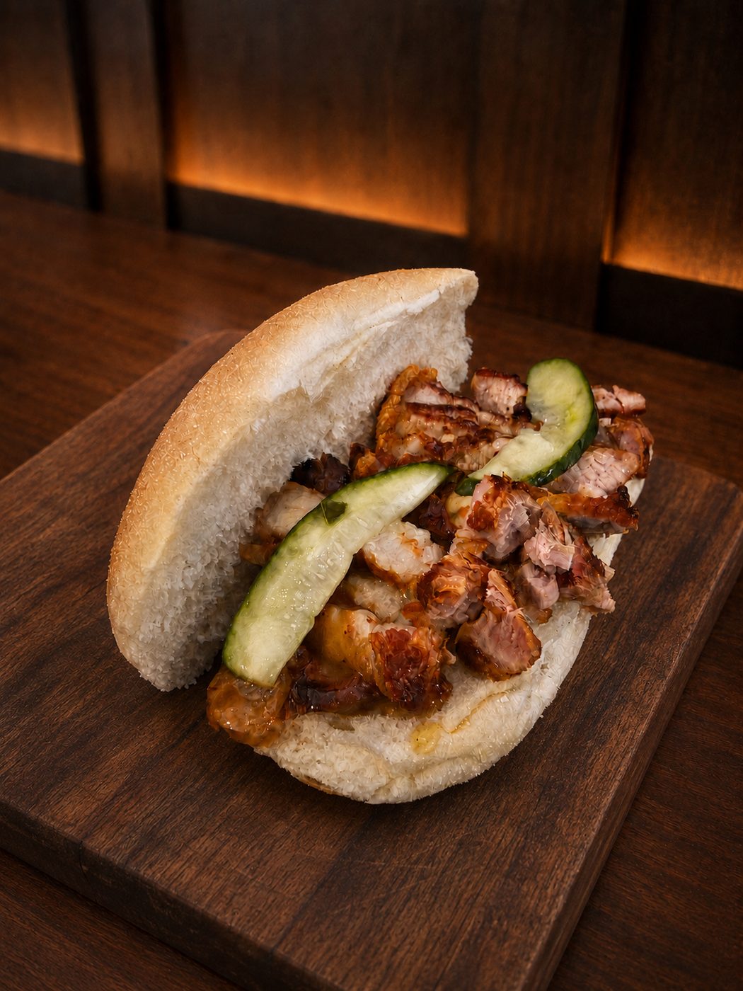 Roll with crispy roast pork belly and cucumber