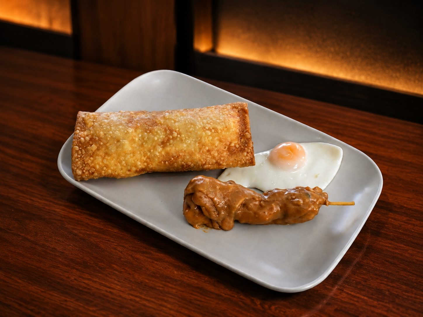 Spring roll special with satay and fried egg