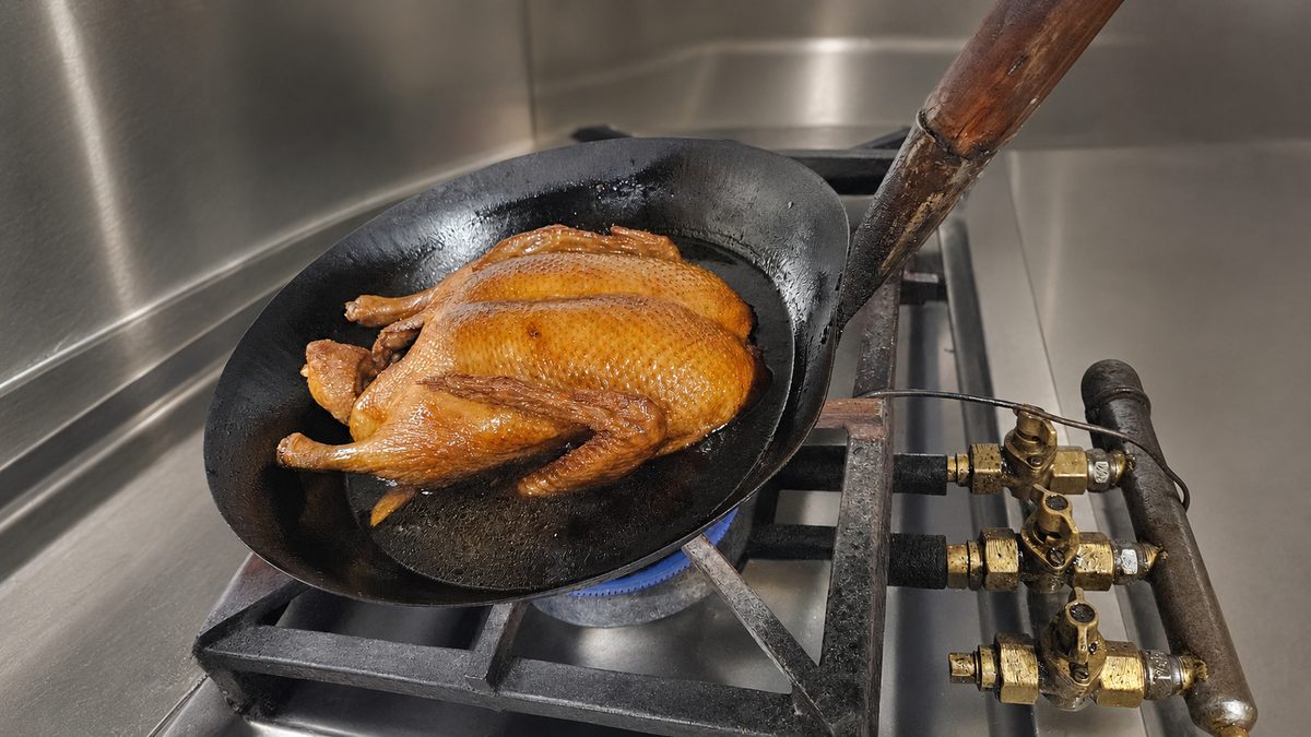 Our chef glazing a duck in the wok